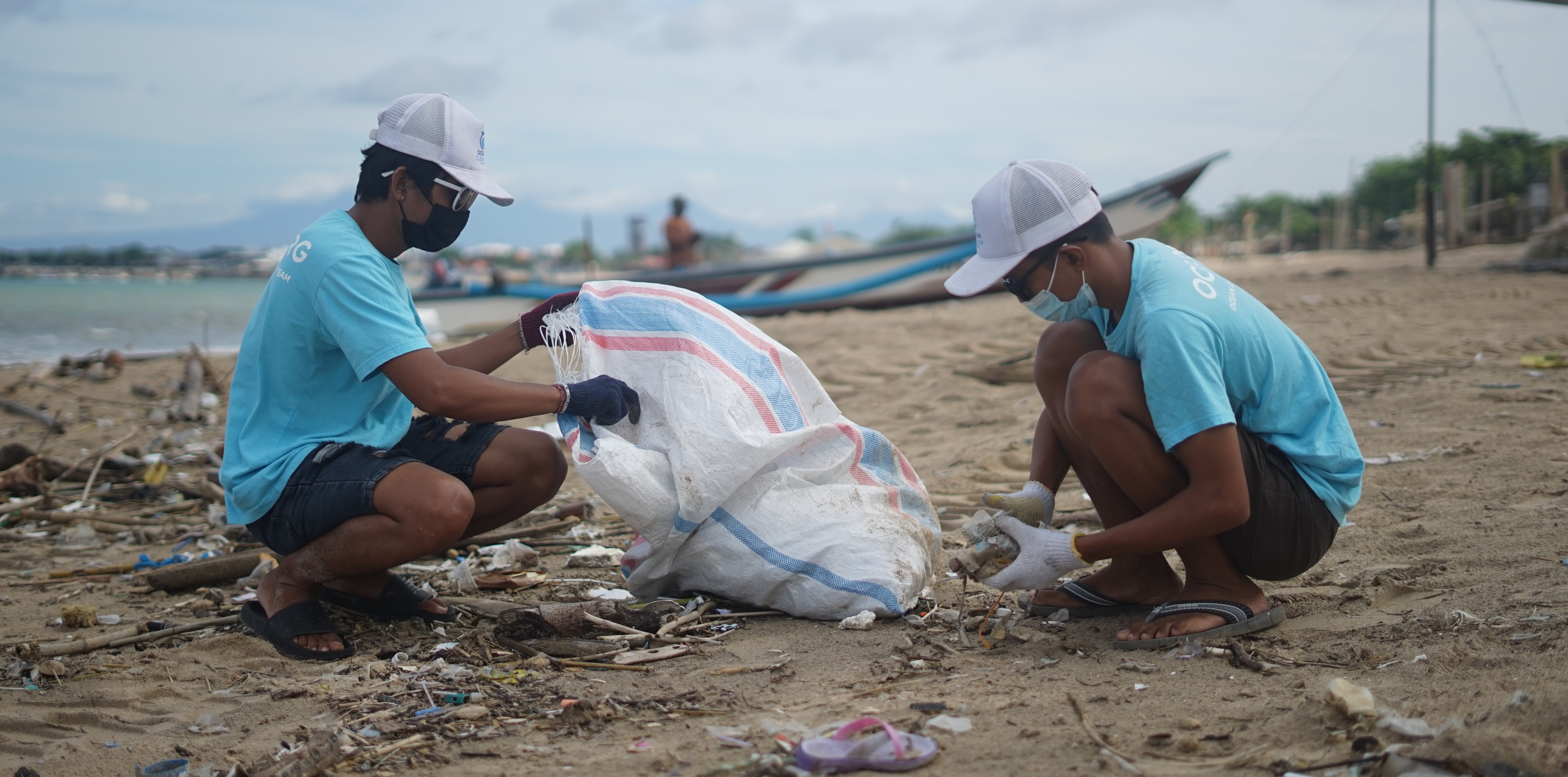 Volunteers picking up litter by the ocean
